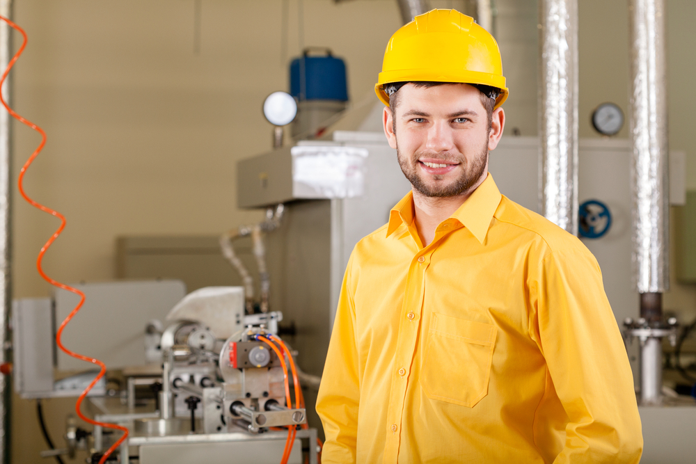 Young engineer during working in factory, horizontal